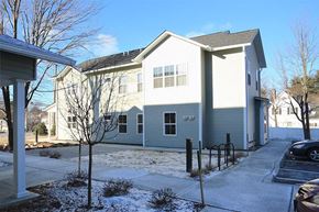 South Burlington apartment for rent - Exterior of two story Rye apartment building in winter
