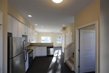 South Burlington apartment for rent - a kitchen with stainless steel appliances and white cabinets