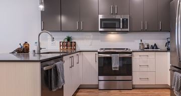 Bellevue apartment for rent - A modern kitchen with a stainless steel oven and white cabinets.