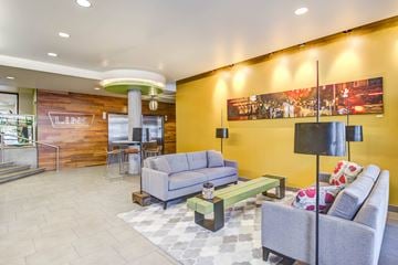 Seattle apartment for rent - A living room with a grey couch and a coffee table.