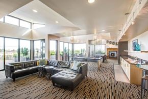 Seattle apartment for rent - A modern living room with a fireplace and a kitchen area.