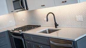 Chicago apartment for rent - Marlowe Apartments Chicago Kitchen Details Tiled Backsplash, Blue Cabinets with Silver and Brass Hardware