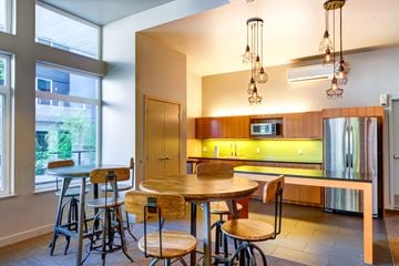 Seattle apartment for rent - A kitchen with a table and chairs in front of a window.