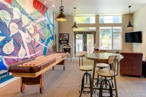 Seattle apartment for rent - A room with a pool table, bar stools, and a television.