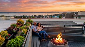 Seattle apartment for rent - A couple sits on a rooftop terrace by a fire pit.