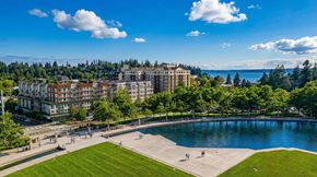 Bellevue apartment for rent - A large building is surrounded by trees and a pool.