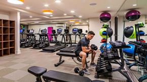 Bellevue apartment for rent - A man is working out in a gym with a variety of equipment.
