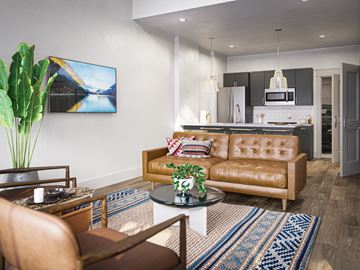 Richmond Hill townhouse for rent - A living room with a brown leather couch and a painting on the wall.