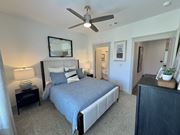 Foley townhouse for rent - A bedroom with a bed, nightstand, and a ceiling fan at Allier Foley, Alabama