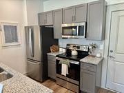 Foley townhouse for rent - A kitchen with a black refrigerator, stove, and microwave at Allier Foley, Foley, Alabama