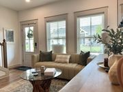 Foley townhouse for rent - A living room with a couch, coffee table, and a plant at Allier Foley, Foley