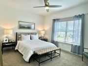 Foley townhouse for rent - A bedroom with a large bed and a ceiling fan at Allier Foley, Foley, AL 36535