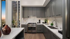 Los Angeles apartment for rent - a kitchen with marble counter tops and gray cabinets