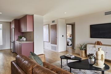 Los Angeles apartment for rent - A living room with a brown leather couch and a black coffee table.