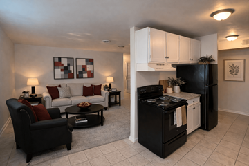 Augusta apartment for rent - A black and white kitchen with a black refrigerator and stove.