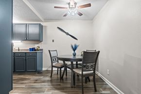 Wichita apartment for rent - a dining room with a table and chairs and a ceiling fan