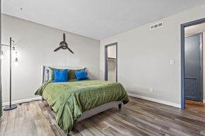 Wichita apartment for rent - a bedroom with a bed and a ceiling fan