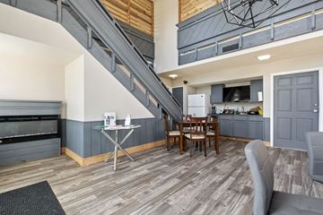 Wichita apartment for rent - A living room with a grey couch and a wooden table.