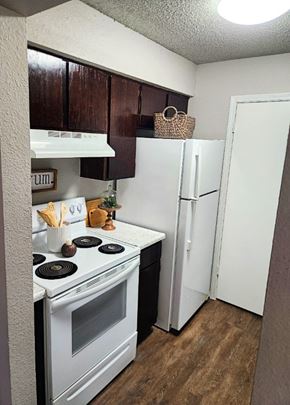 Stillwater apartment for rent - A kitchen with a white stove top oven and a white refrigerator.