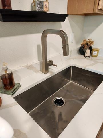 Tulsa apartment for rent - A modern kitchen sink with a chrome faucet.