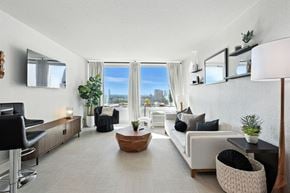 Tulsa apartment for rent - A modern living room with a view of the city.