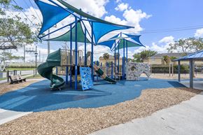 Naples apartment for rent - A playground with a blue slide and a green slide.