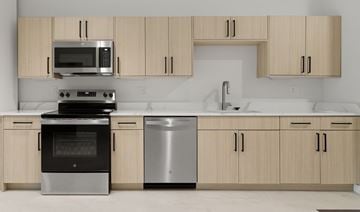 Tulsa apartment for rent - A modern kitchen with wooden cabinets and stainless steel appliances.