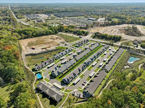 Howell apartment for rent - A bird's eye view of a residential area with houses and a swimming pool.