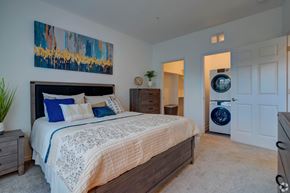 Howell apartment for rent - A bedroom with a large bed and a painting on the wall.