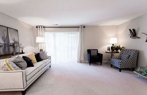 Kentwood apartment for rent - A living room with a white couch and a painting on the wall.