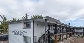Lakewood apartment for rent - Cascade Village Apartments is a white building with a black railing.