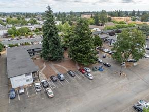 Lakewood apartment for rent - A parking lot with cars and trees in the foreground.