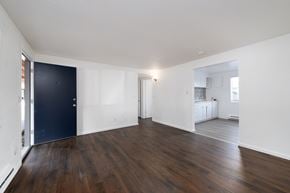 Lakewood apartment for rent - A room with a dark blue door and wooden floors.