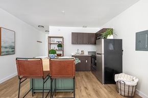 Centralia apartment for rent - A kitchen with a table and chairs and a refrigerator.