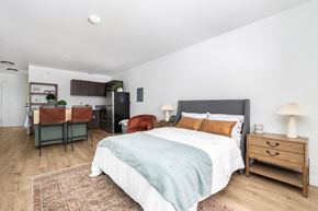 Centralia apartment for rent - A bedroom with a bed, nightstand, and chair.