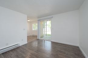 Tacoma apartment for rent - A room with a sliding glass door leading to a backyard.