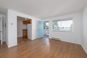 Lakewood apartment for rent - A room with wooden floors and white walls.