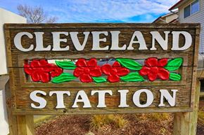 Gresham apartment for rent - A wooden sign that says Cleveland Station with red flowers on it.