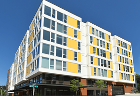 Seattle apartment for rent - a yellow and white building on a city street
