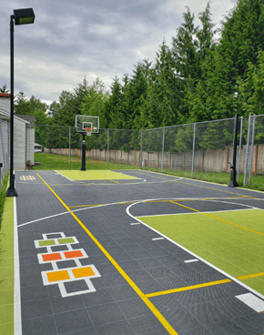 Bothell apartment for rent - a basketball court in a park with a fence and trees