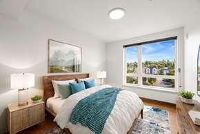 Seattle apartment for rent - a bedroom with a bed and a large window