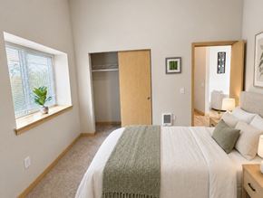 Wenatchee apartment for rent - A bedroom with a bed, a window, a door, and a lamp.