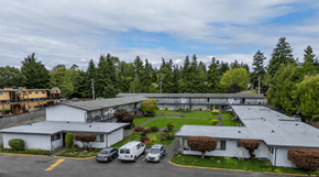 Federal Way apartment for rent - A large white building with a parking lot in front of it.