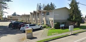 Marysville apartment for rent - A street view of a residential area with apartment buildings and parked cars.