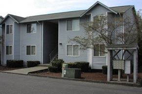 Burlington apartment for rent - A grey two story apartment building with a mailbox in front.