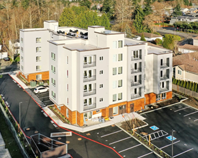 Everett apartment for rent - A large white building with a red line in the parking lot.