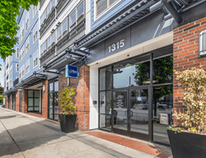 Everett apartment for rent - the front of a building with glass doors and a sidewalk