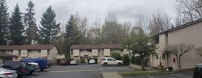 Bellevue apartment for rent - a parking lot with cars in front of an apartment building