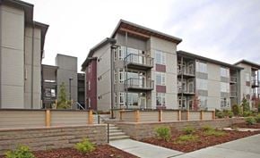 Lynnwood apartment for rent - Apartment buildings with balconies and a brick wall in front.