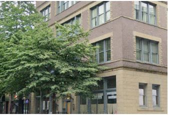 Seattle apartment for rent - a large brick building with a tree in front of it